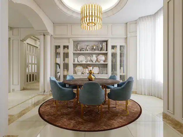 dining room with brown round table blue upholstered chairs shelves with kitchen decor brown carpet