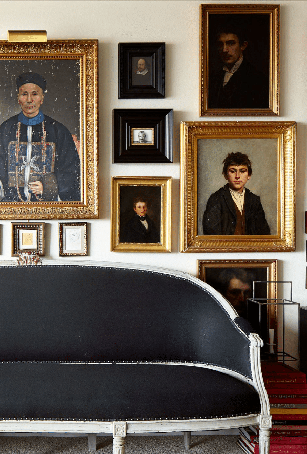 gallery wall of antique gilt frames and timeless photos