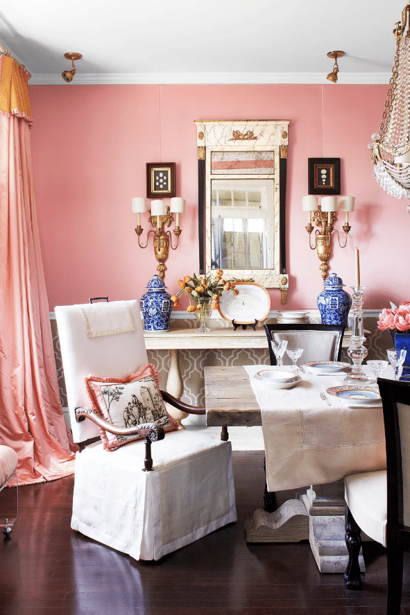 coral paint, curtains, ornate lighting, and gold furnishings emphasize