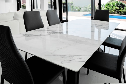 Luxurious Marble Dining Table With Black Chairs.