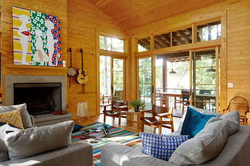lake house. First, place a soft color sofa with wooden chairs and a side table in the room