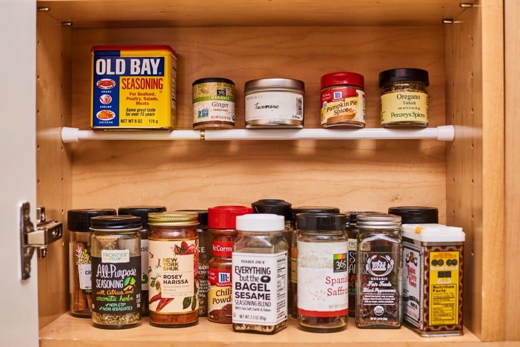 Use a Tension Rod to Create an Extra Shelf for Canned Goods