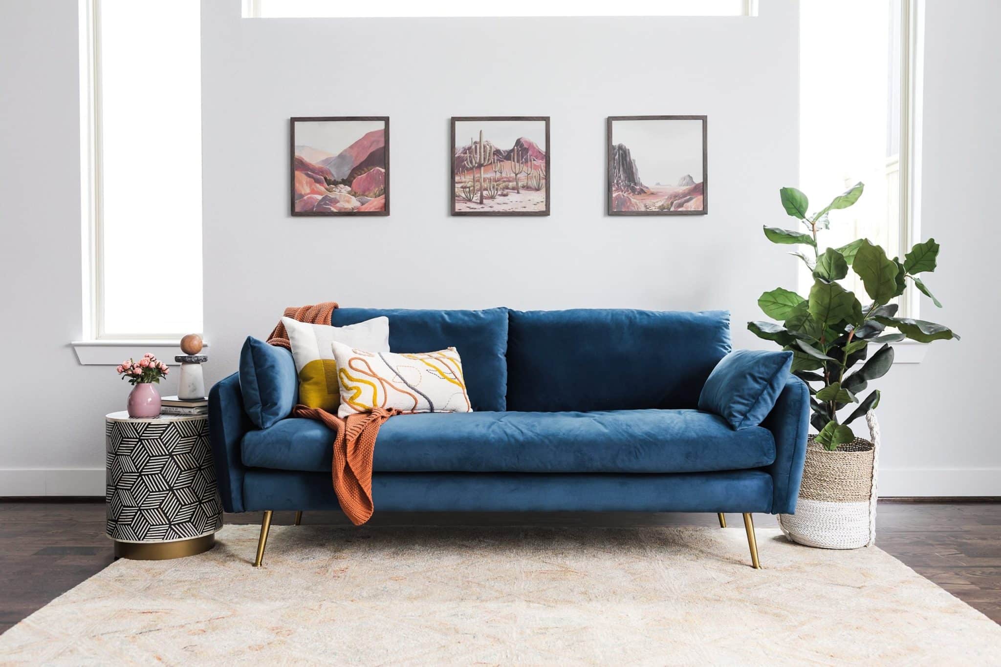 Can a blue velvet sofa be paired with other velvet furniture or decor in the room