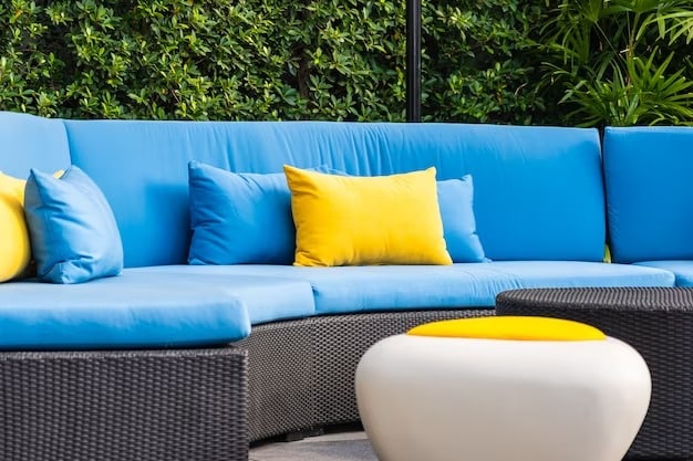 Outdoor furniture with blue cushions and yellow pillows,