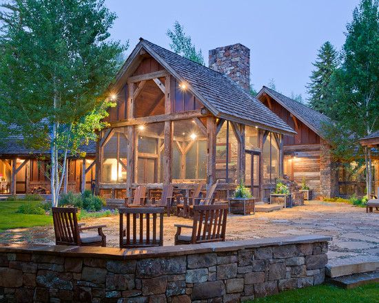 A cozy log home with a stone patio