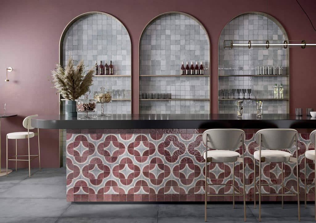 A bar with a pink tile floor and a white counter, showcasing the artistic technique of Color Drenching