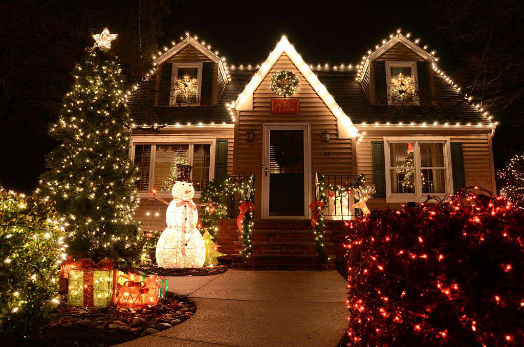 A festively adorned house with colorful Christmas lights and decorations on its exterior