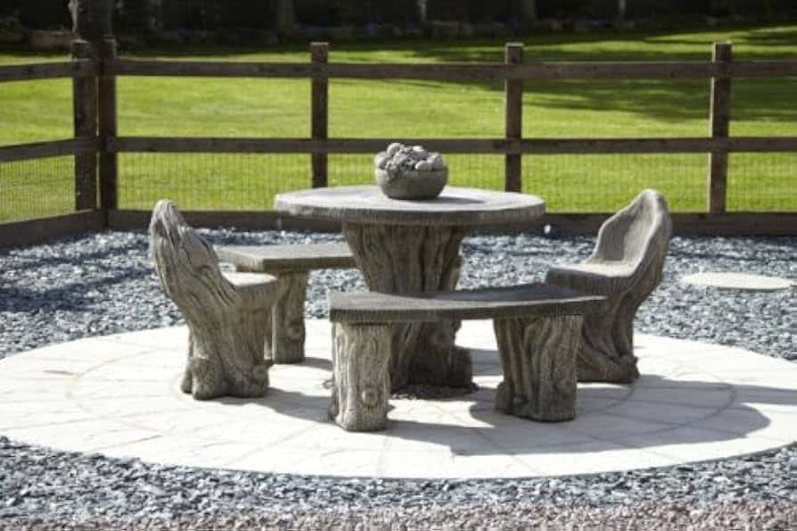 Stone table and chairs in a gravel area,