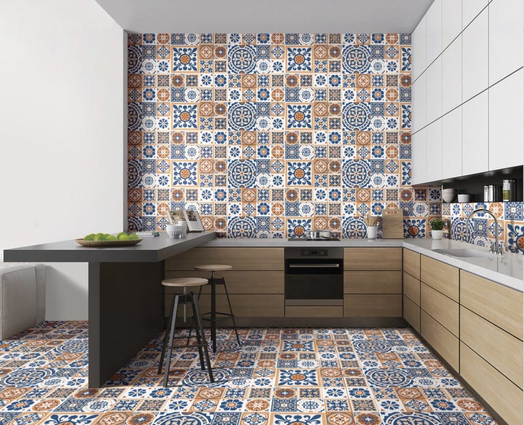 A kitchen with handcrafted blue and orange tiles on the walls, adding a vibrant touch to the decor