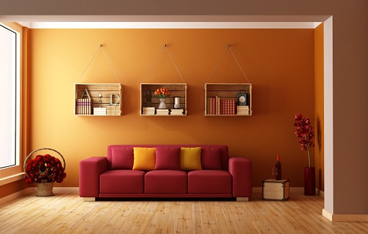 Living room with red sofa and wooden crates used as a bookcase  - 3D Rendering