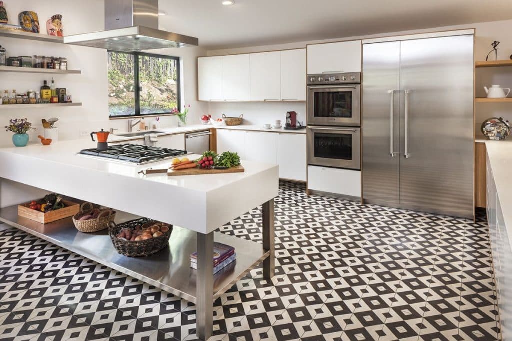Kitchen with black and white checkered floor, adorned with patterned tiles