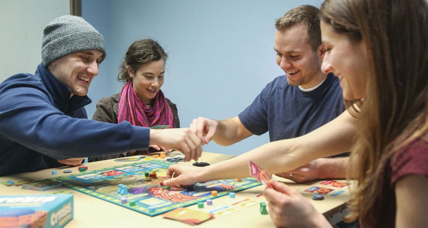 A group of friends playing board games and card game