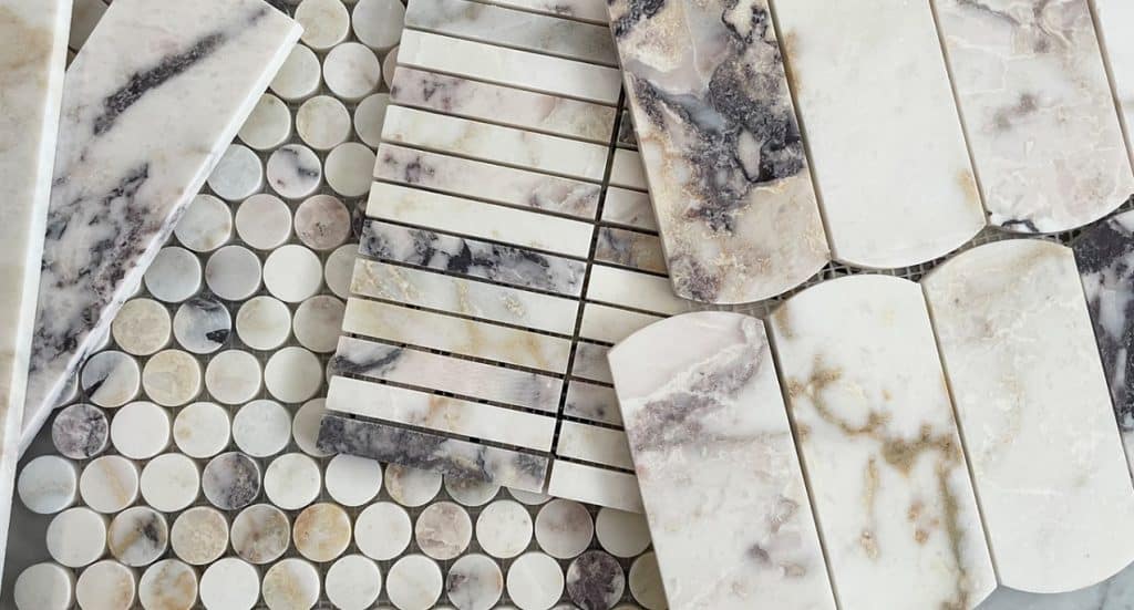 Marble tile assortment displayed on a counter, showcasing the latest trend in tiles for 2024